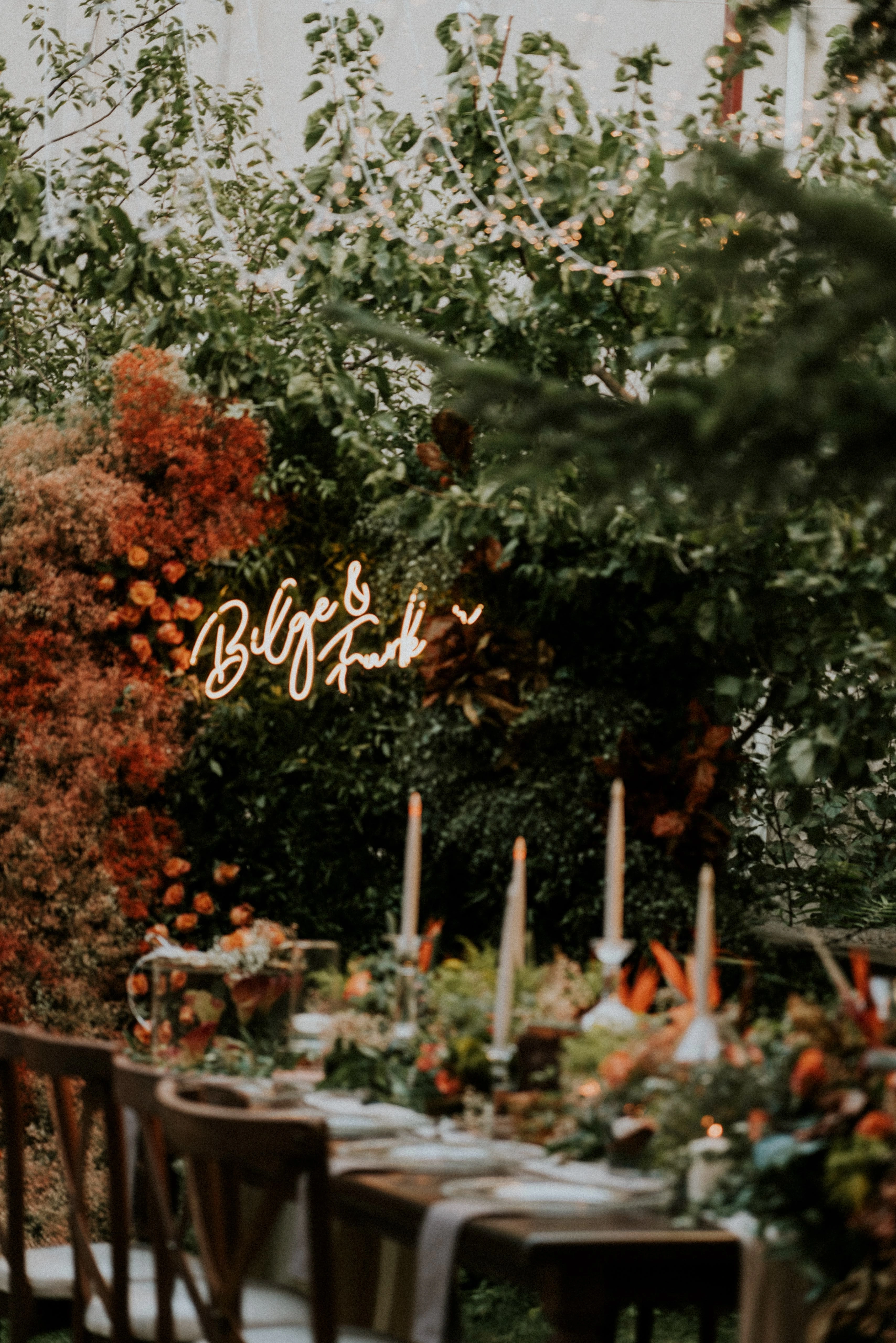 Engagement table surrounded by candles and orange flowers