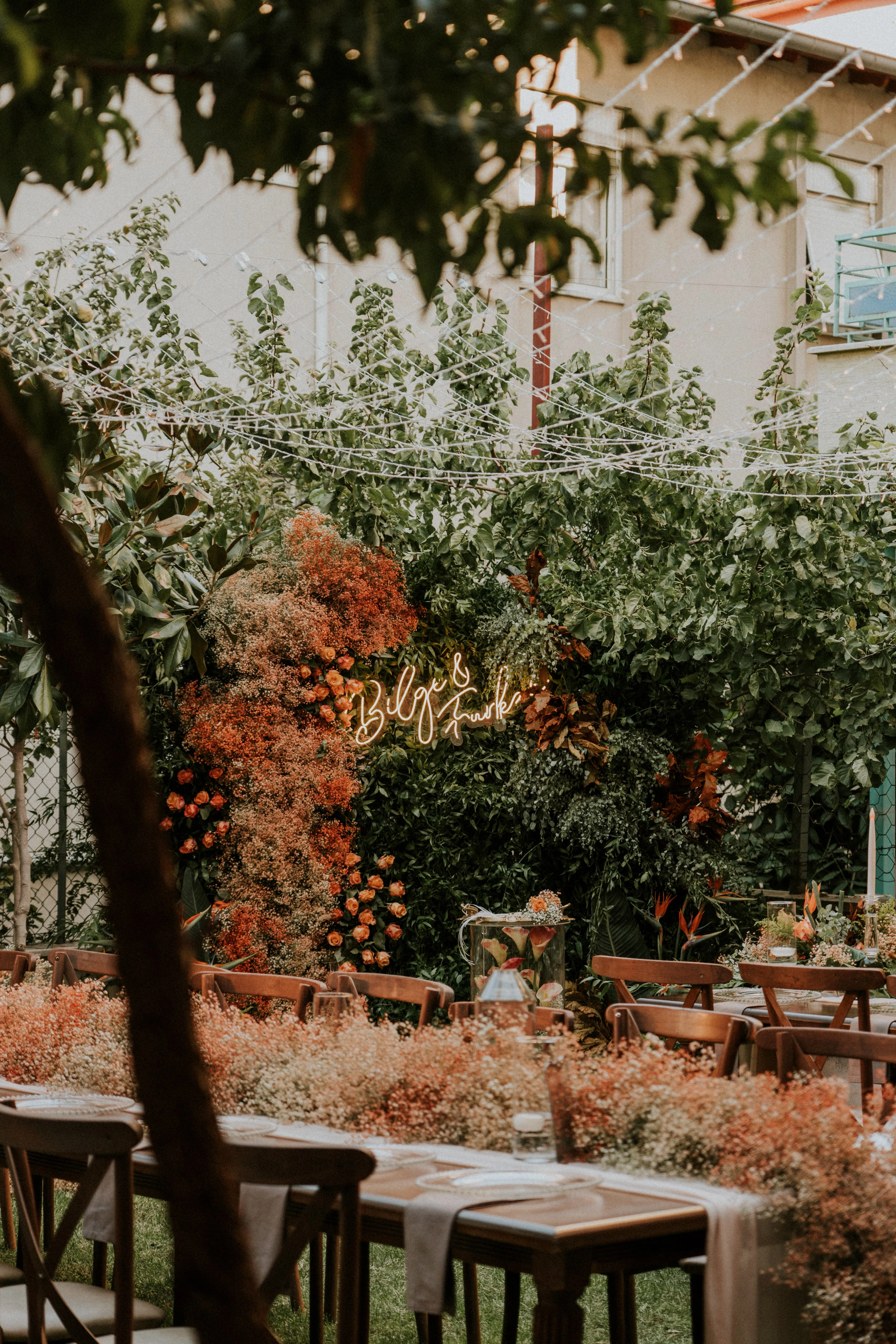 Floral backdrop and long table perspective in the garden