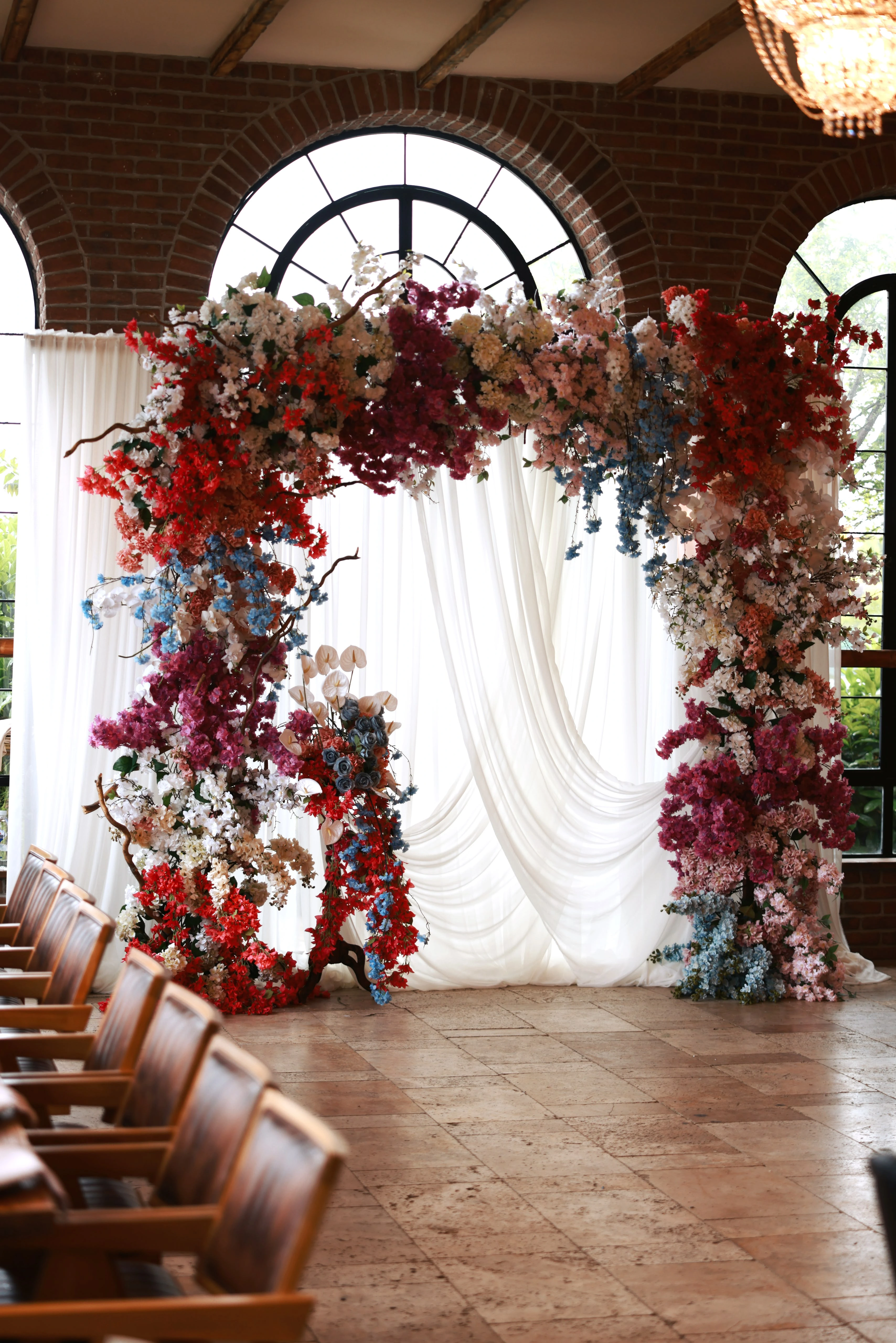 Engagement arch of burgundy, blush and white flowers