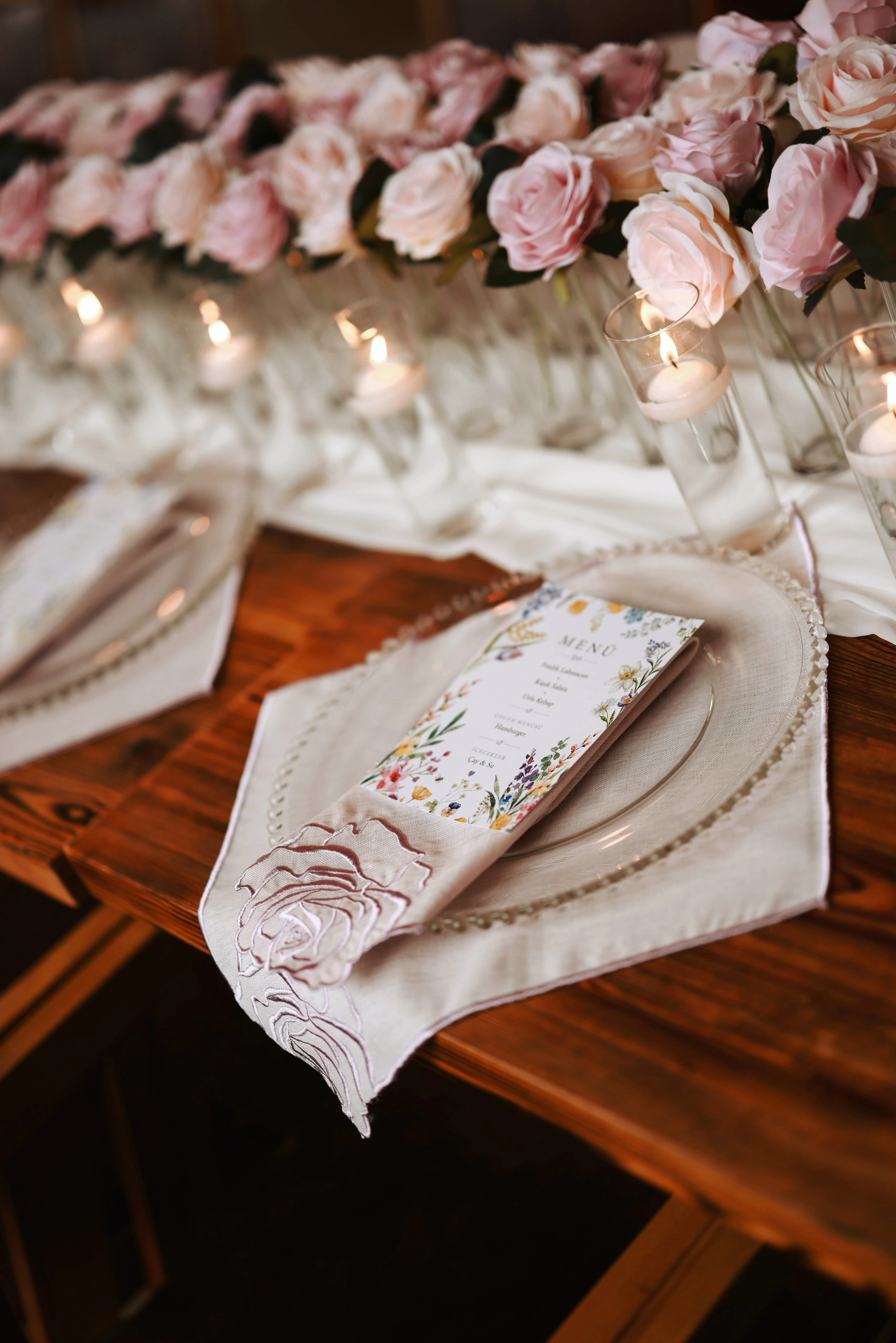 Engagement table detail with a blush napkin and flowers