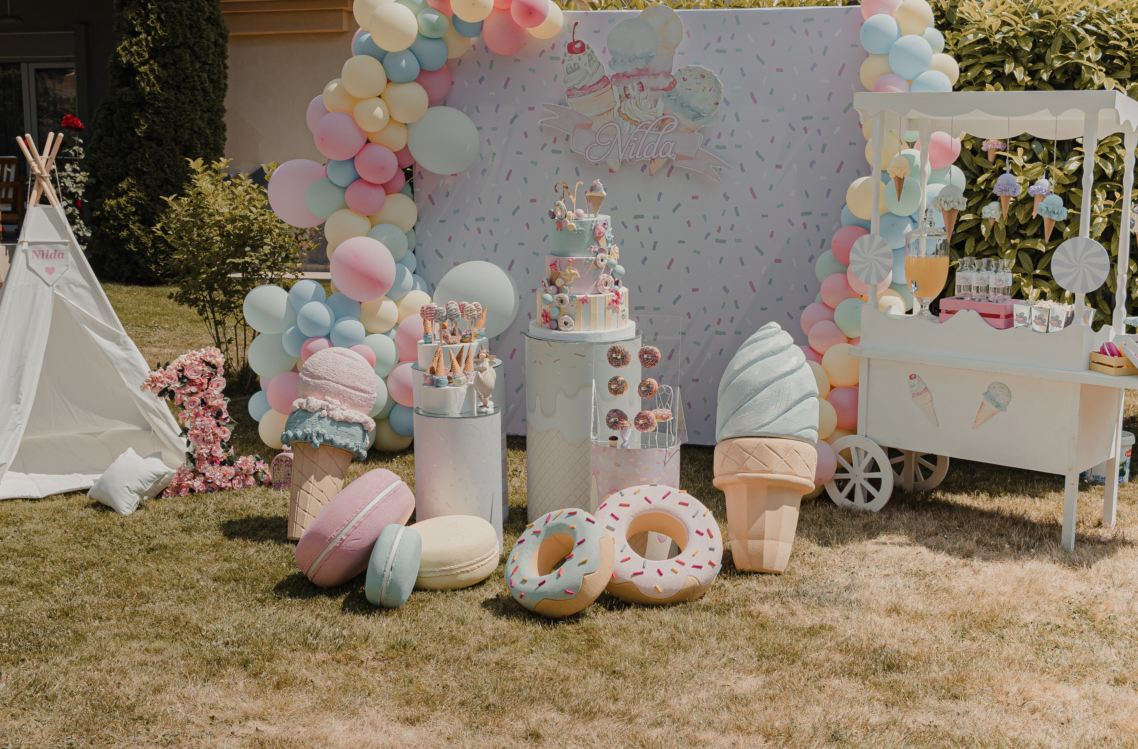 Ice cream-themed scene framed by pastel balloons