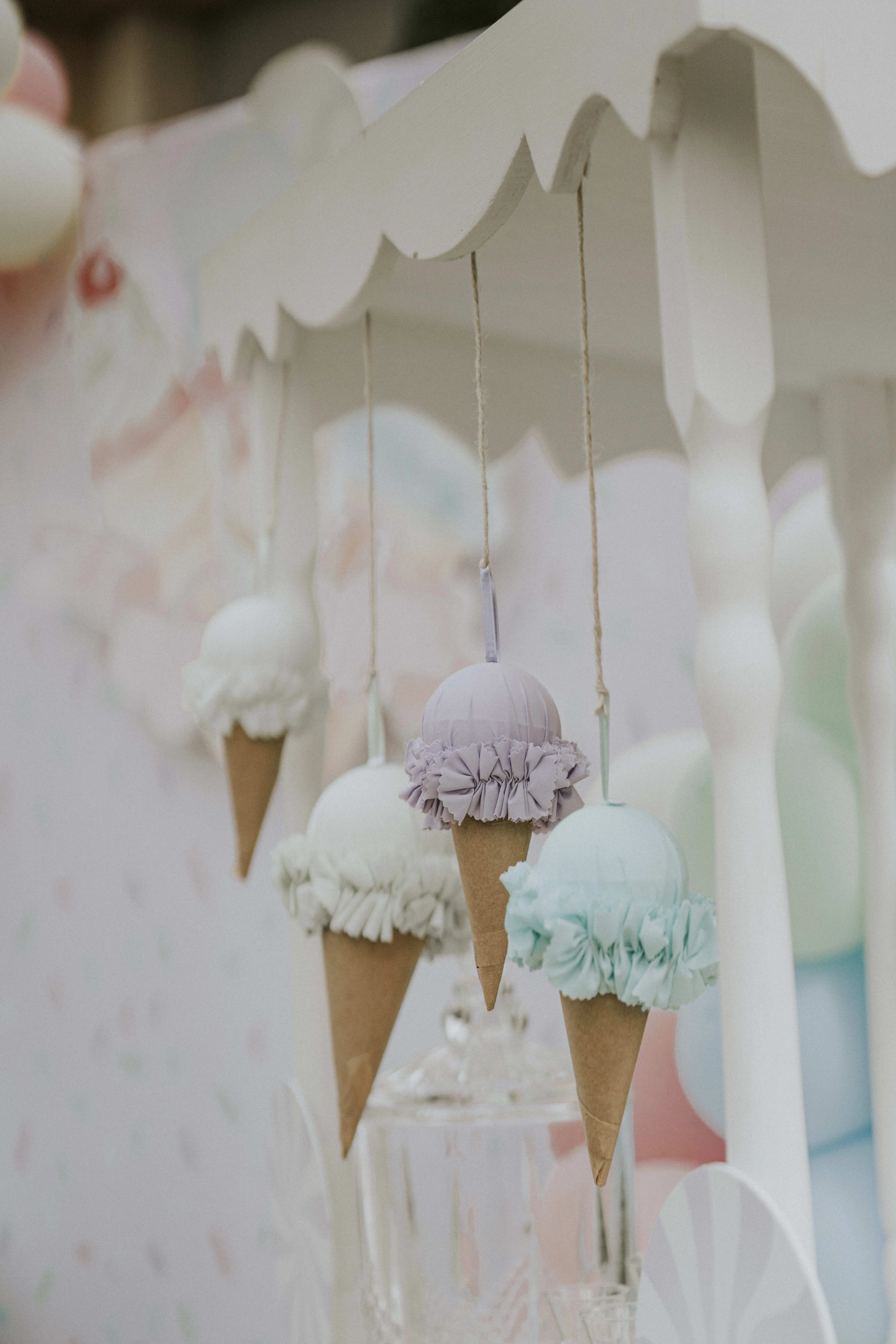 Ice cream cone ornaments hanging from the cart's canopy