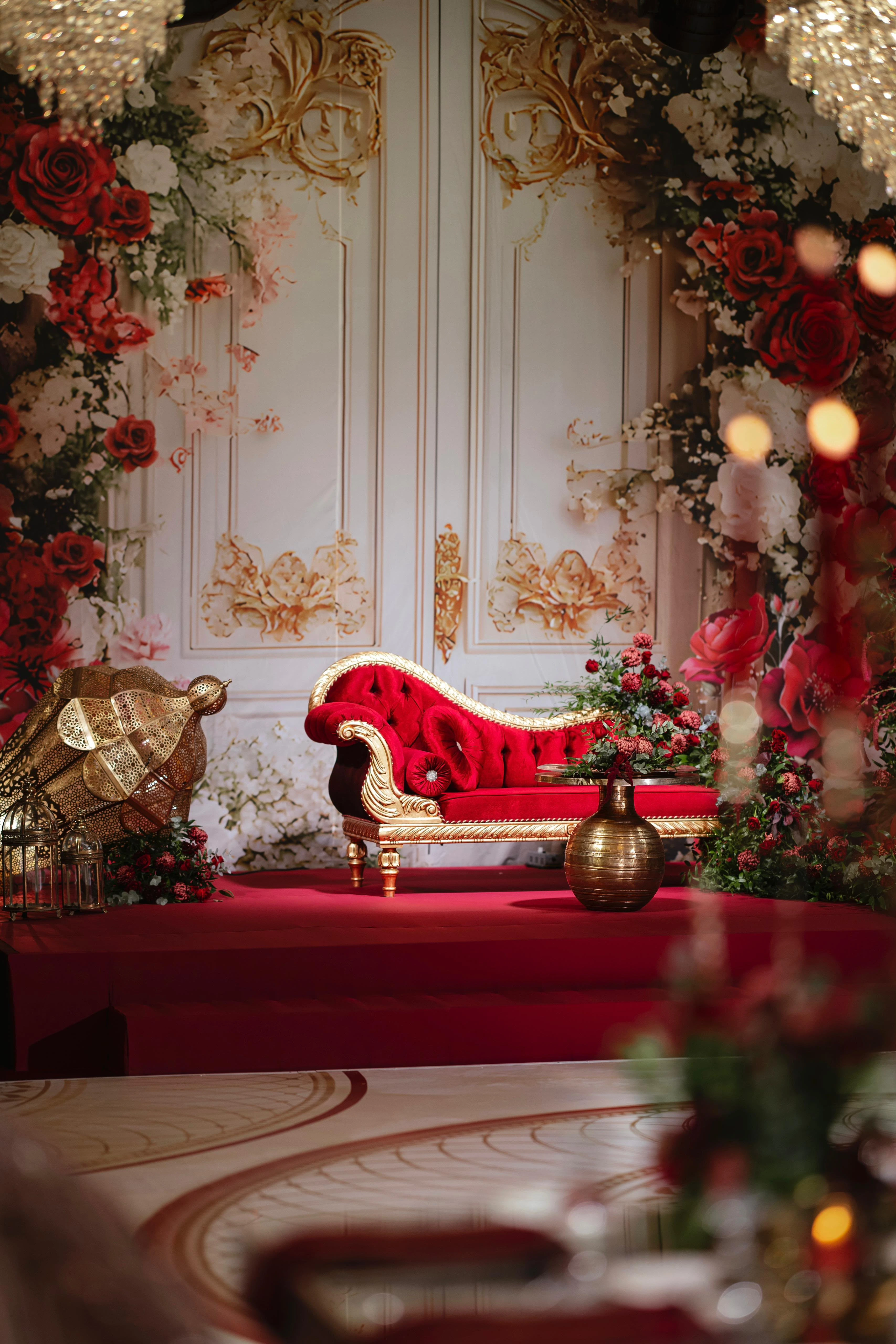 Red velvet henna throne in front of classical panels