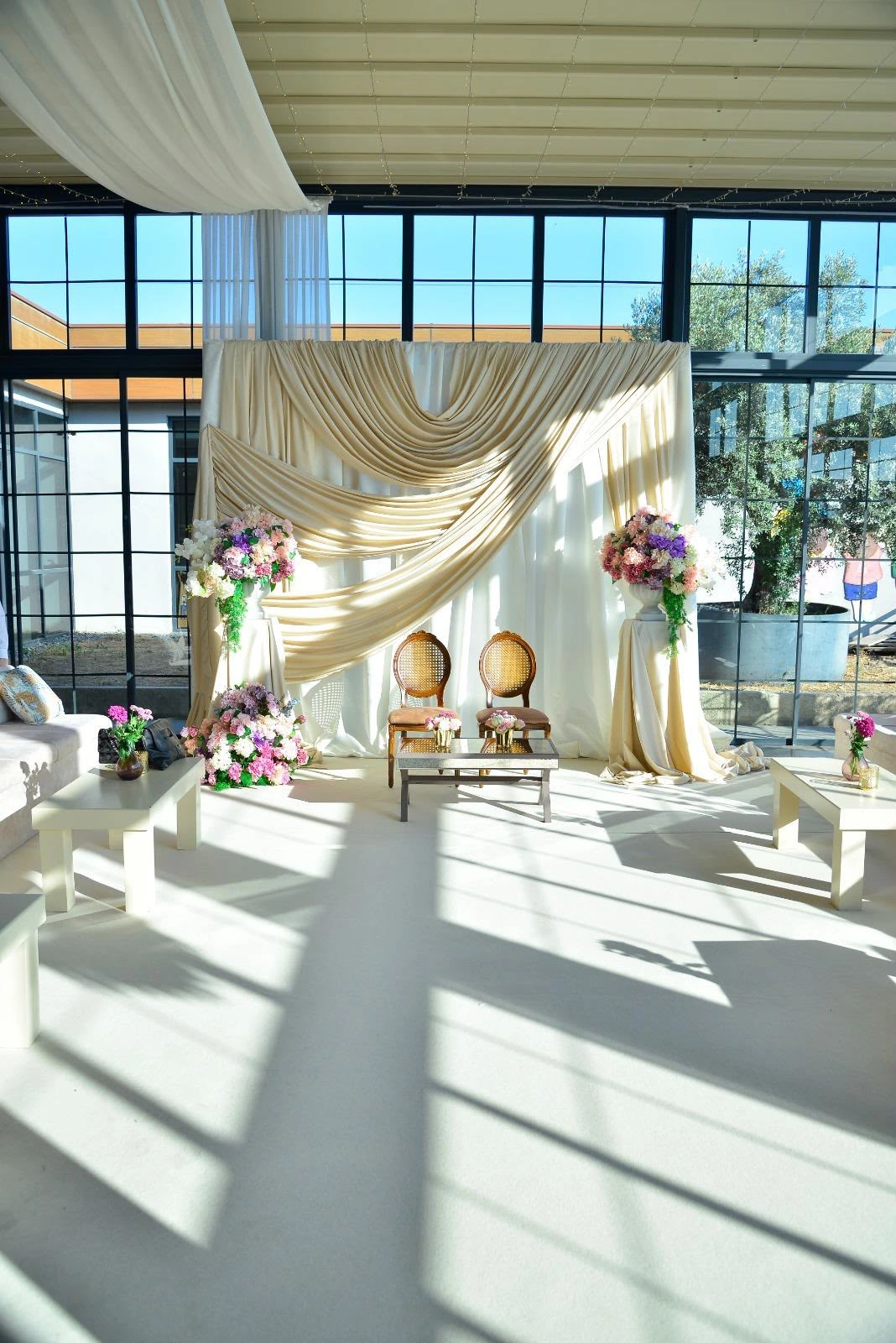 Engagement setting with ivory drapes and flowers, view 2