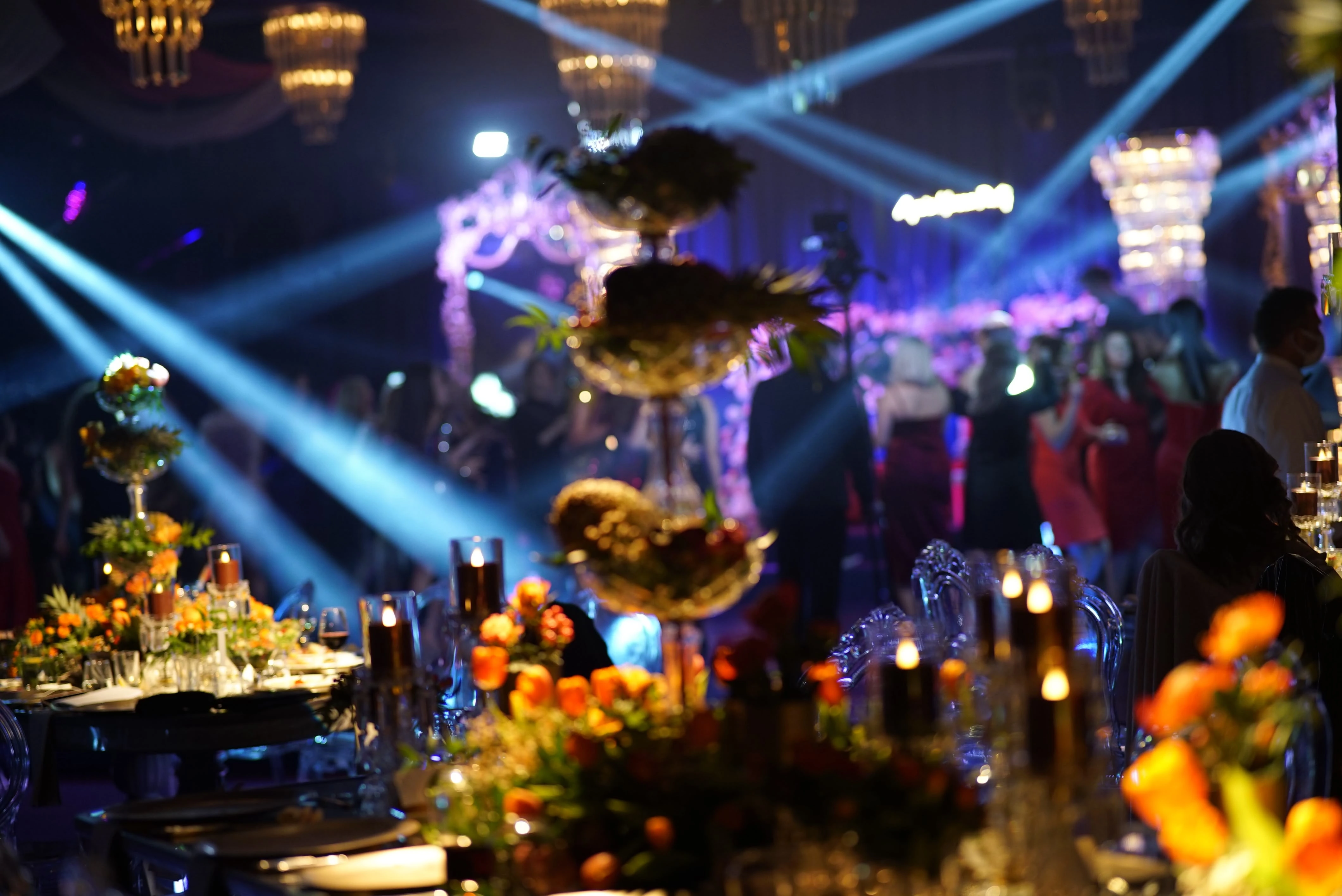 Reception hall surrounded by gold lights and stage beams