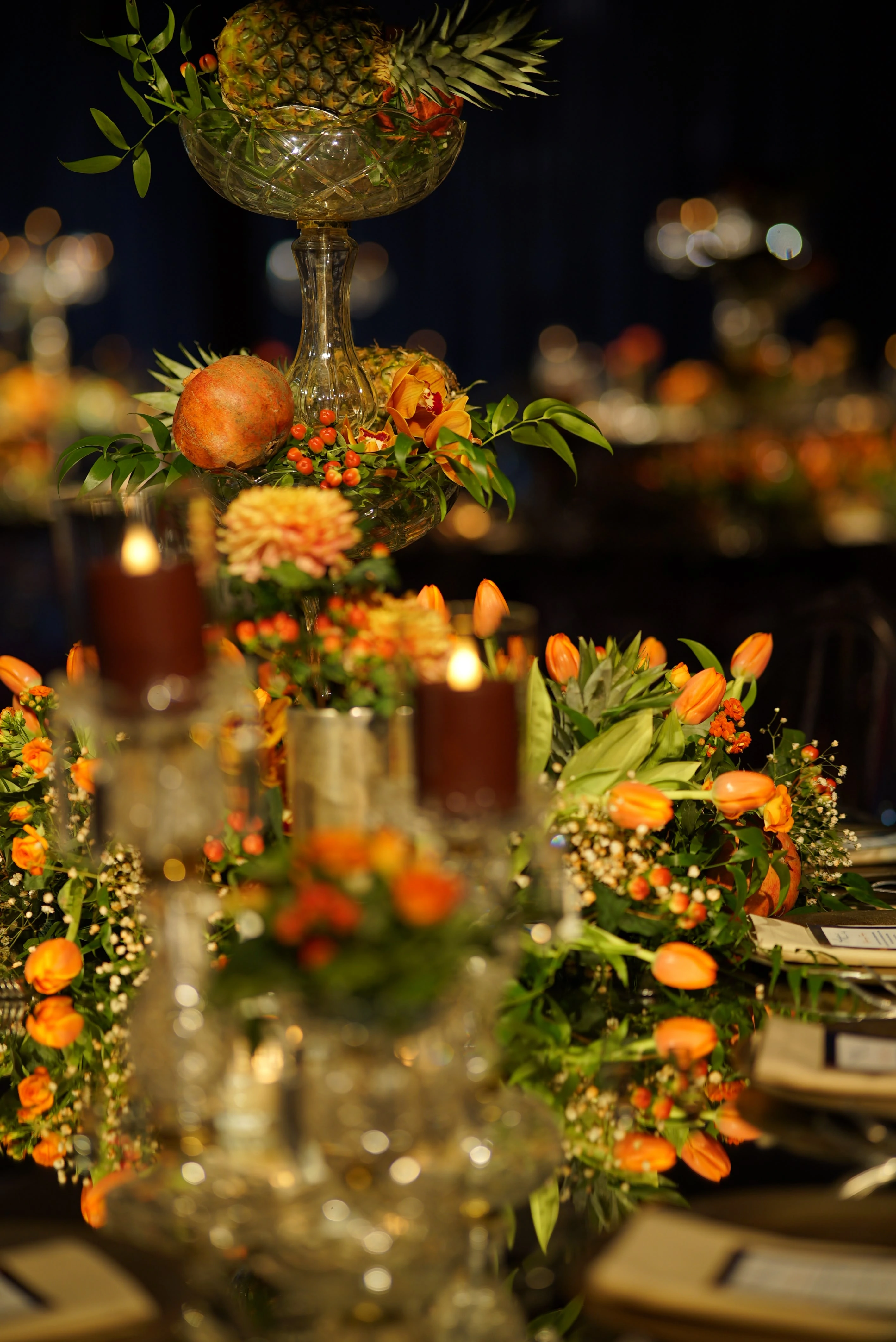 Table set with glassware and citrus-toned flowers