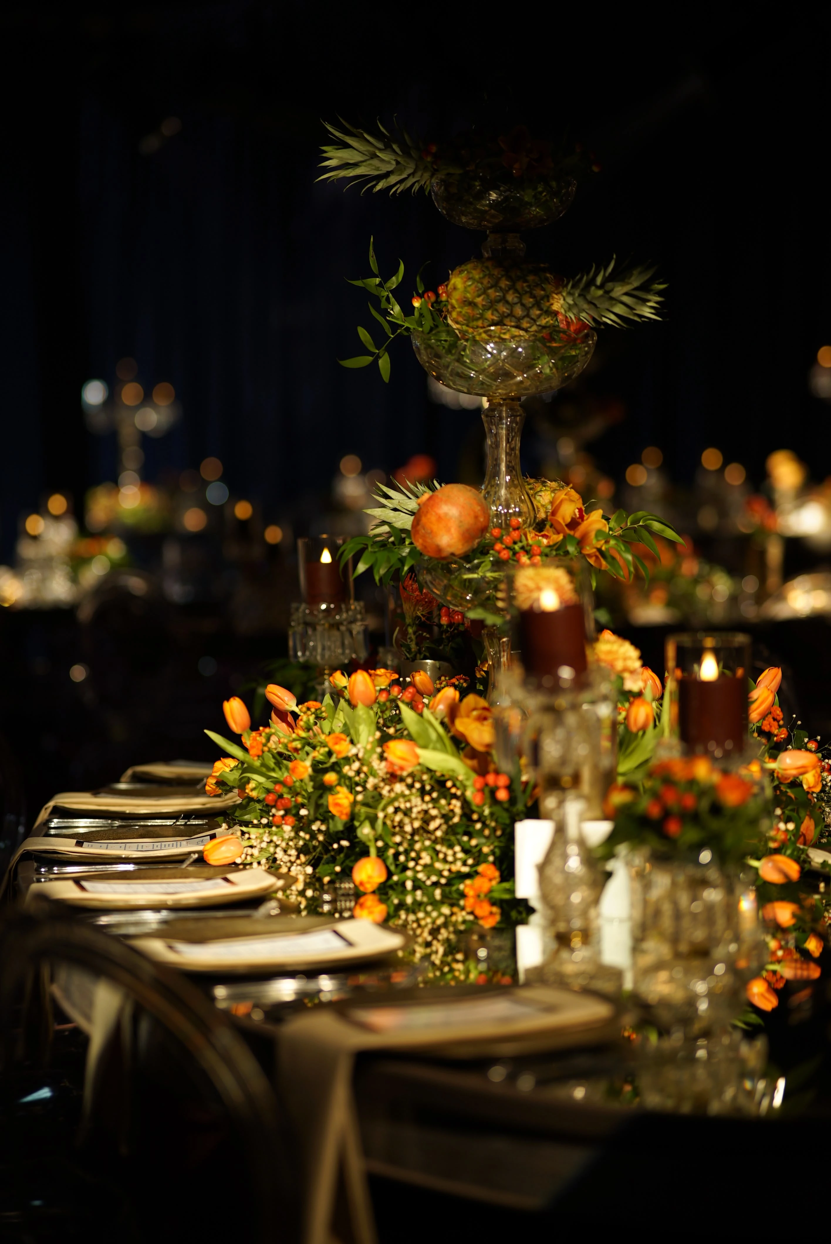 Close-up of orange flowers in candlelight