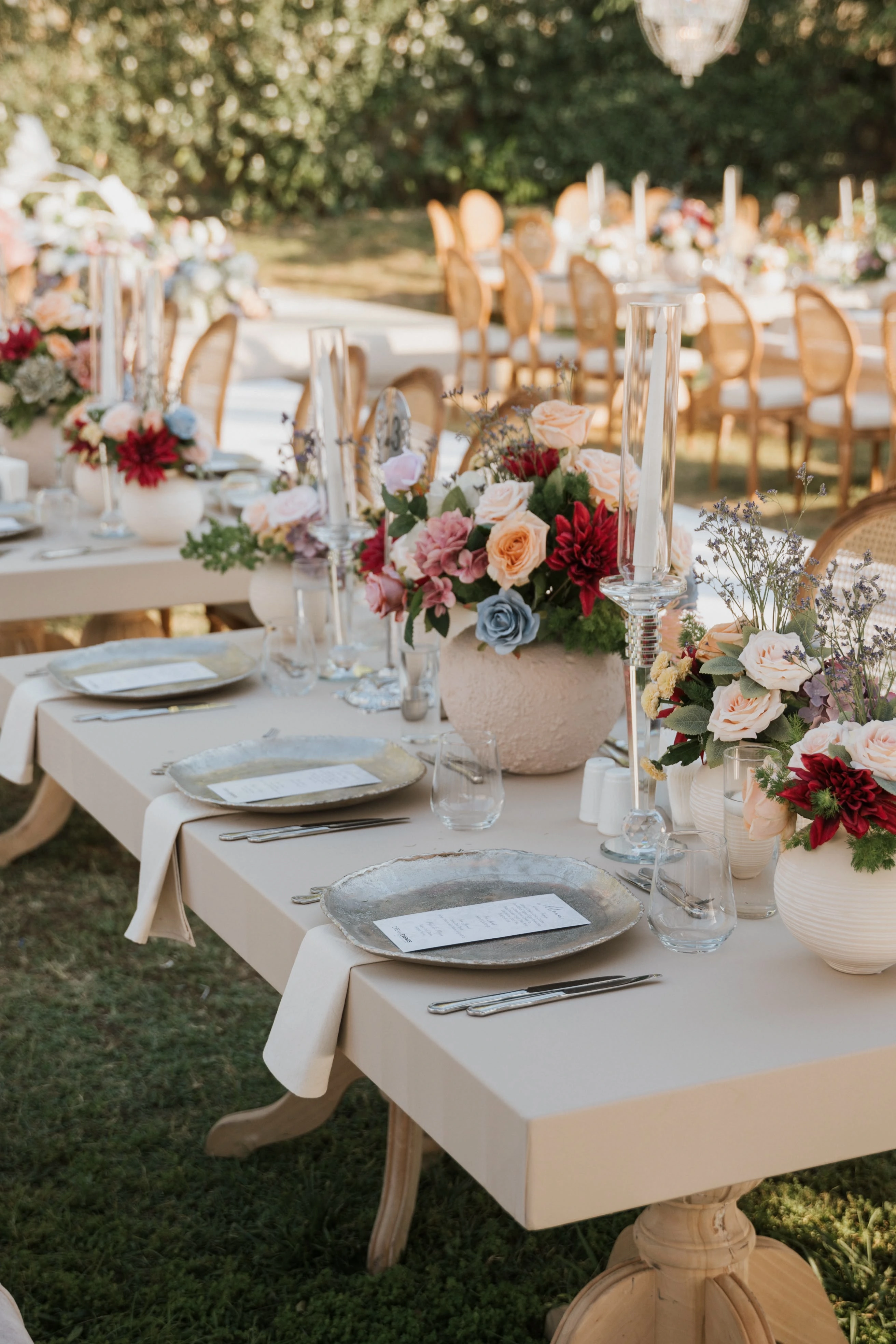 Garden engagement with crystal chandeliers, pastel flowers and wooden chairs, view 4