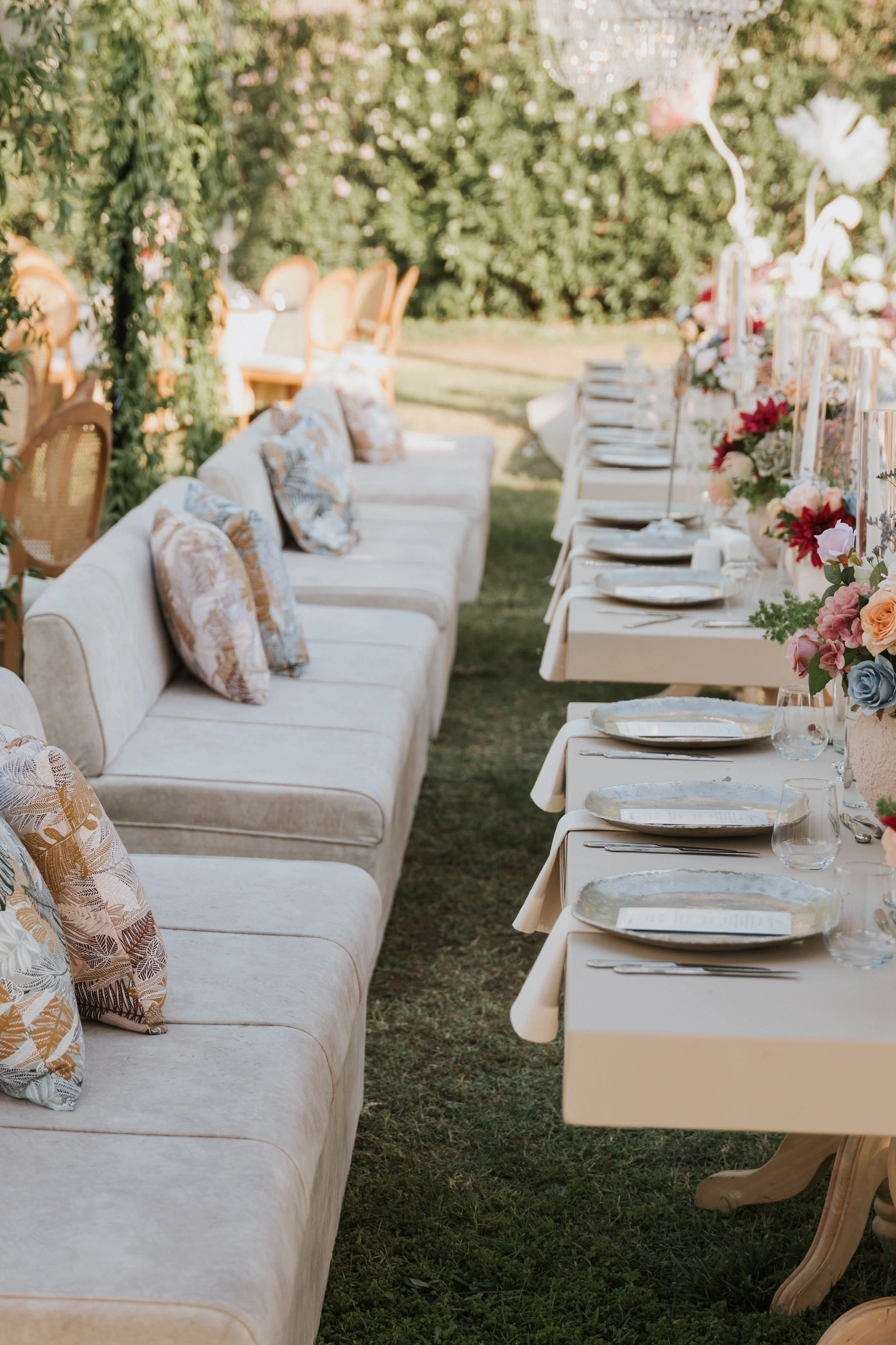 Garden engagement with crystal chandeliers, pastel flowers and wooden chairs, view 5