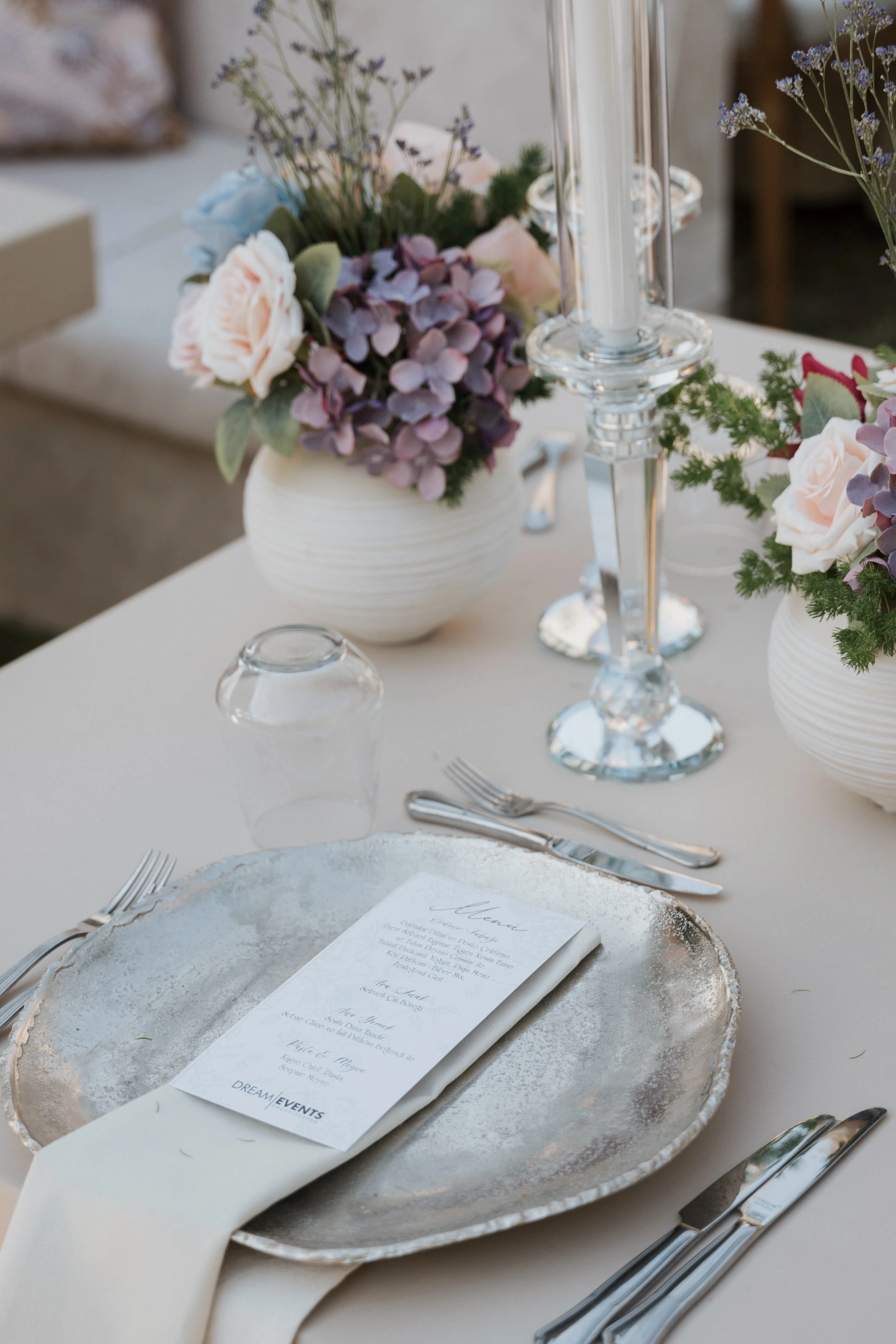 Garden engagement with crystal chandeliers, pastel flowers and wooden chairs, view 6