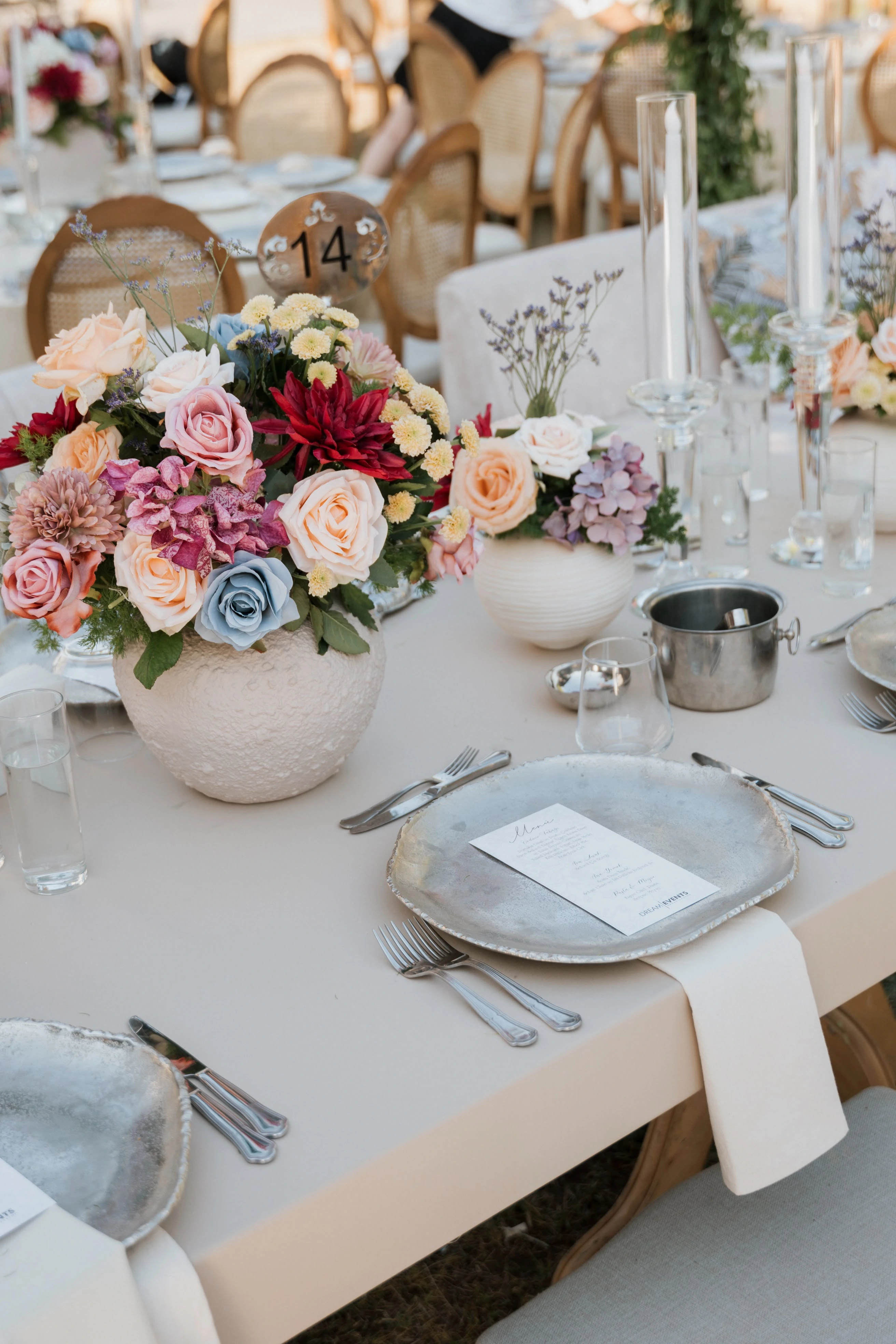 Garden engagement with crystal chandeliers, pastel flowers and wooden chairs, view 7