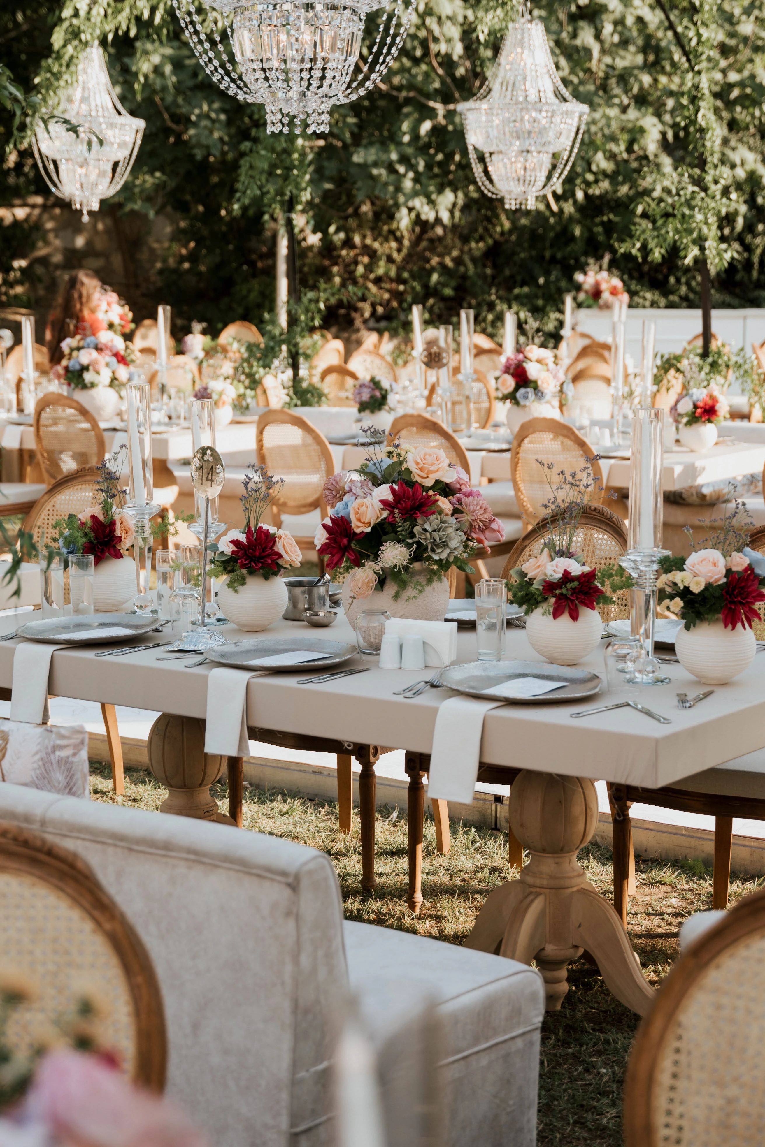 Garden engagement with crystal chandeliers, pastel flowers and wooden chairs, view 9