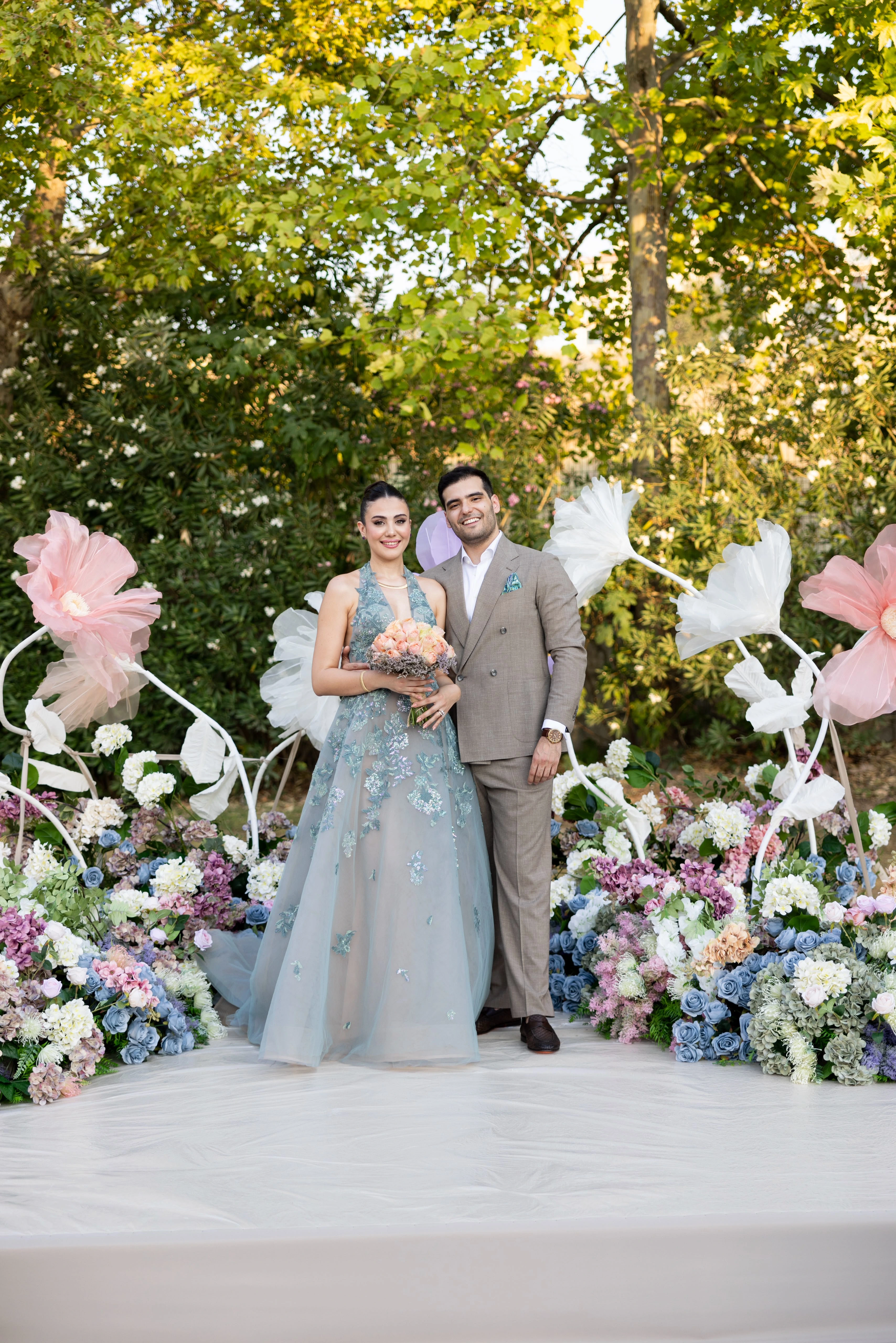 Garden engagement with crystal chandeliers, pastel flowers and wooden chairs, view 10