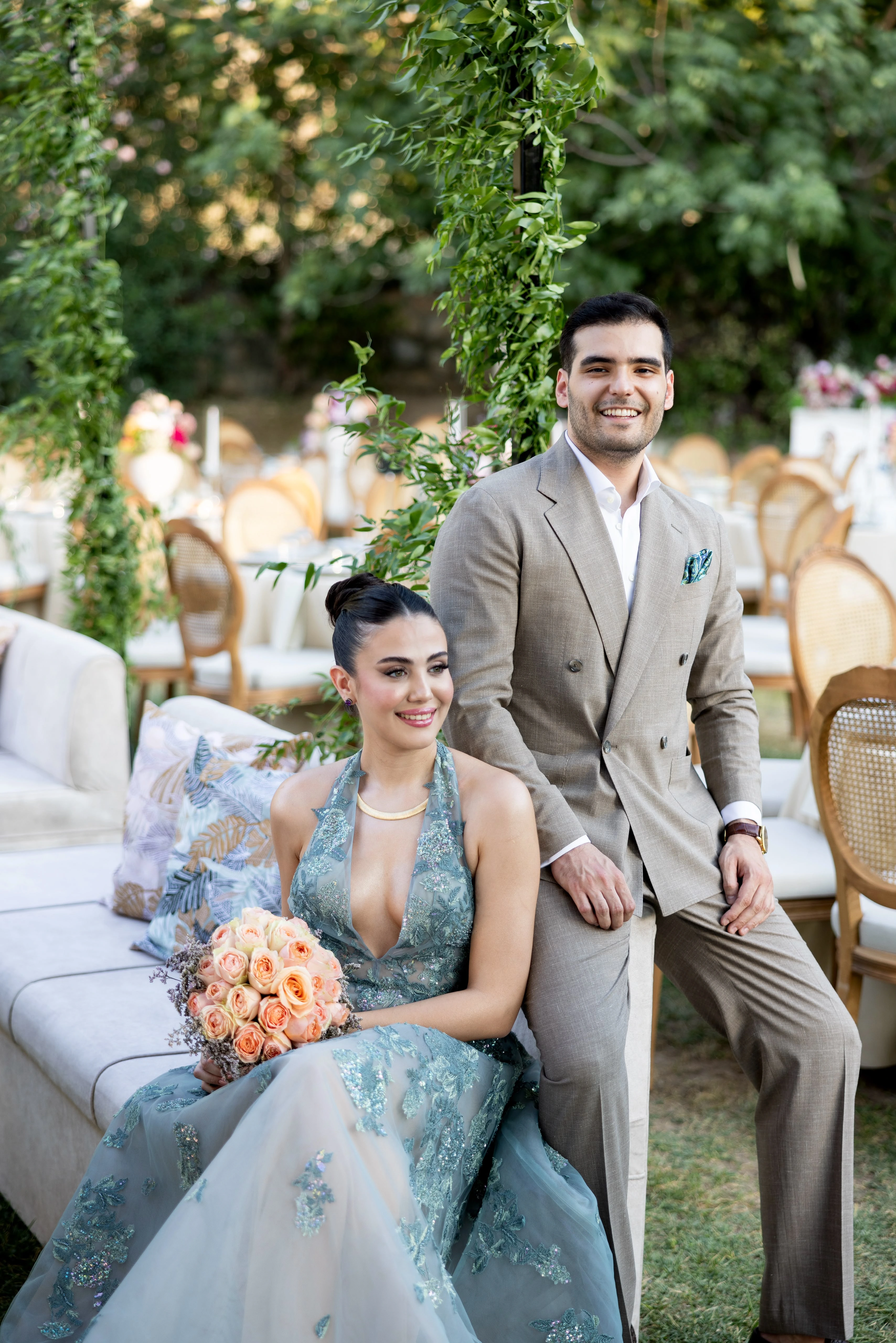 Garden engagement with crystal chandeliers, pastel flowers and wooden chairs, view 11