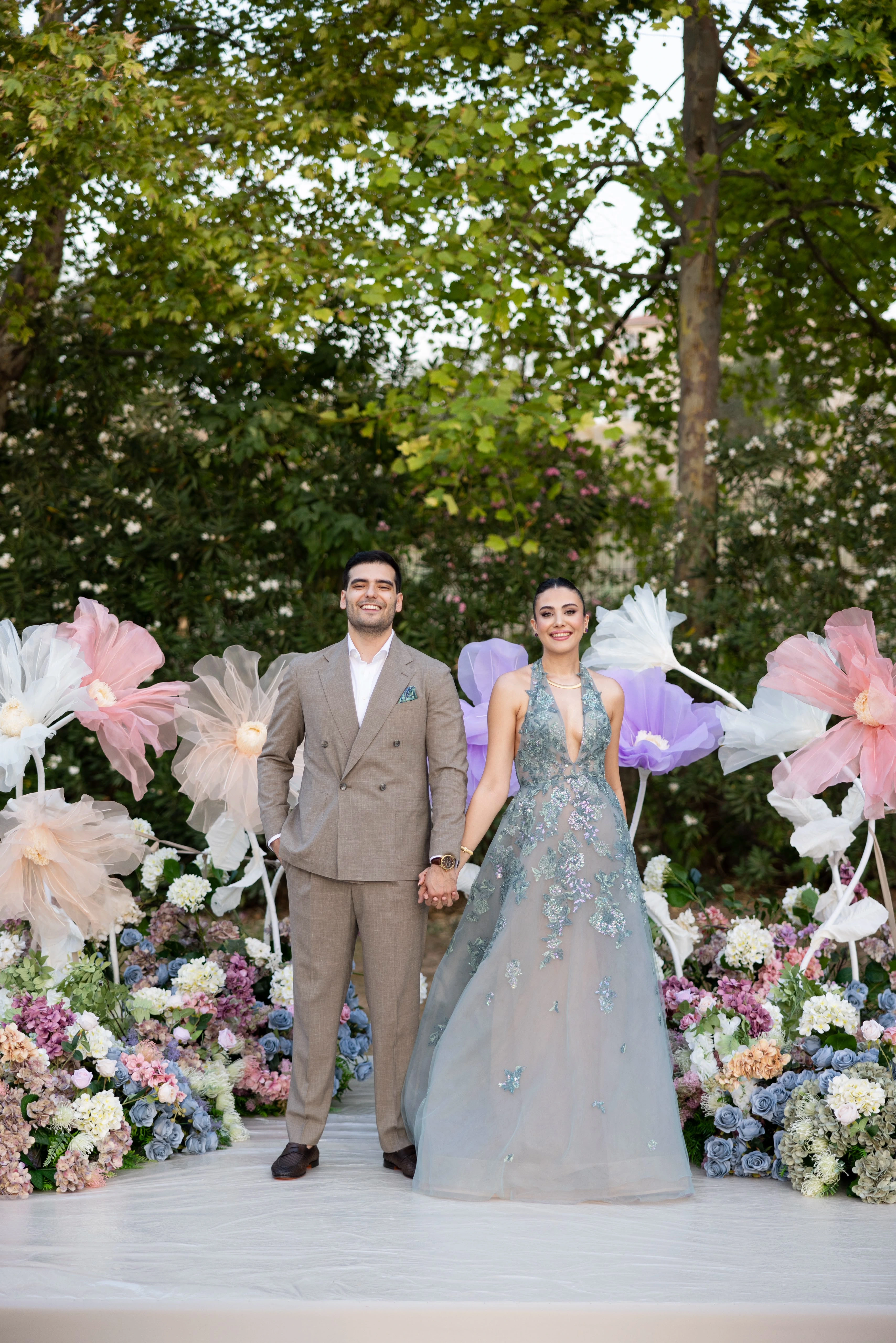 Garden engagement with crystal chandeliers, pastel flowers and wooden chairs, view 13