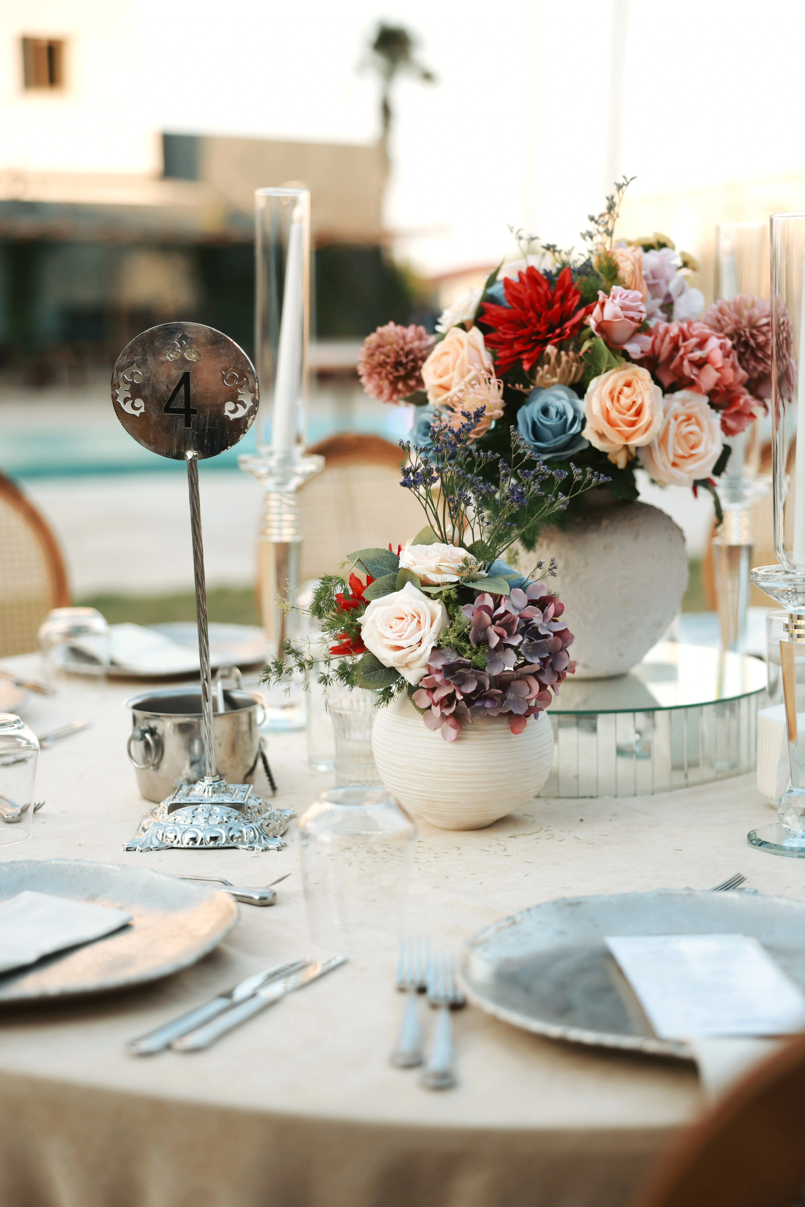 Garden engagement with crystal chandeliers, pastel flowers and wooden chairs, view 14
