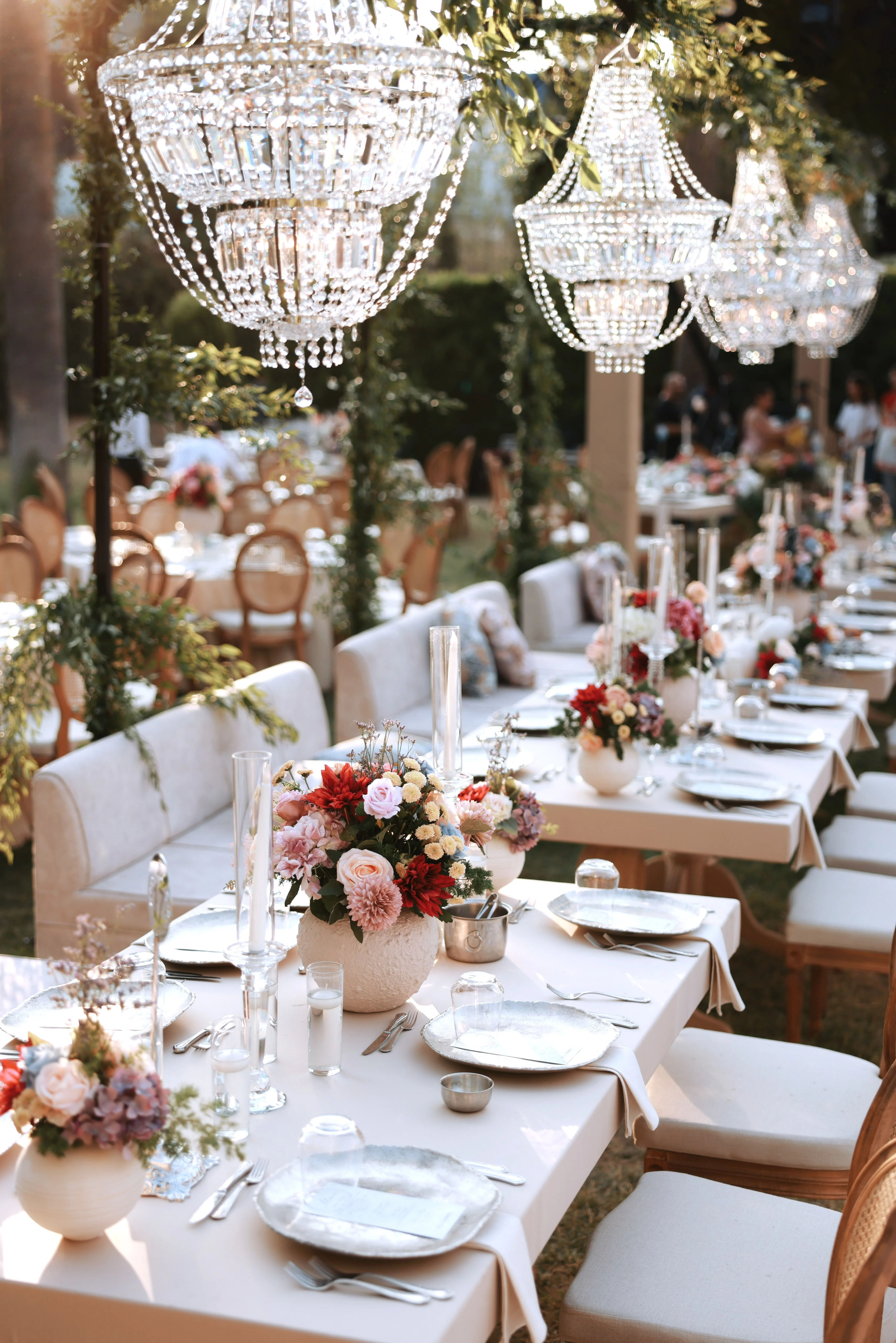 Garden engagement with crystal chandeliers, pastel flowers and wooden chairs, view 16