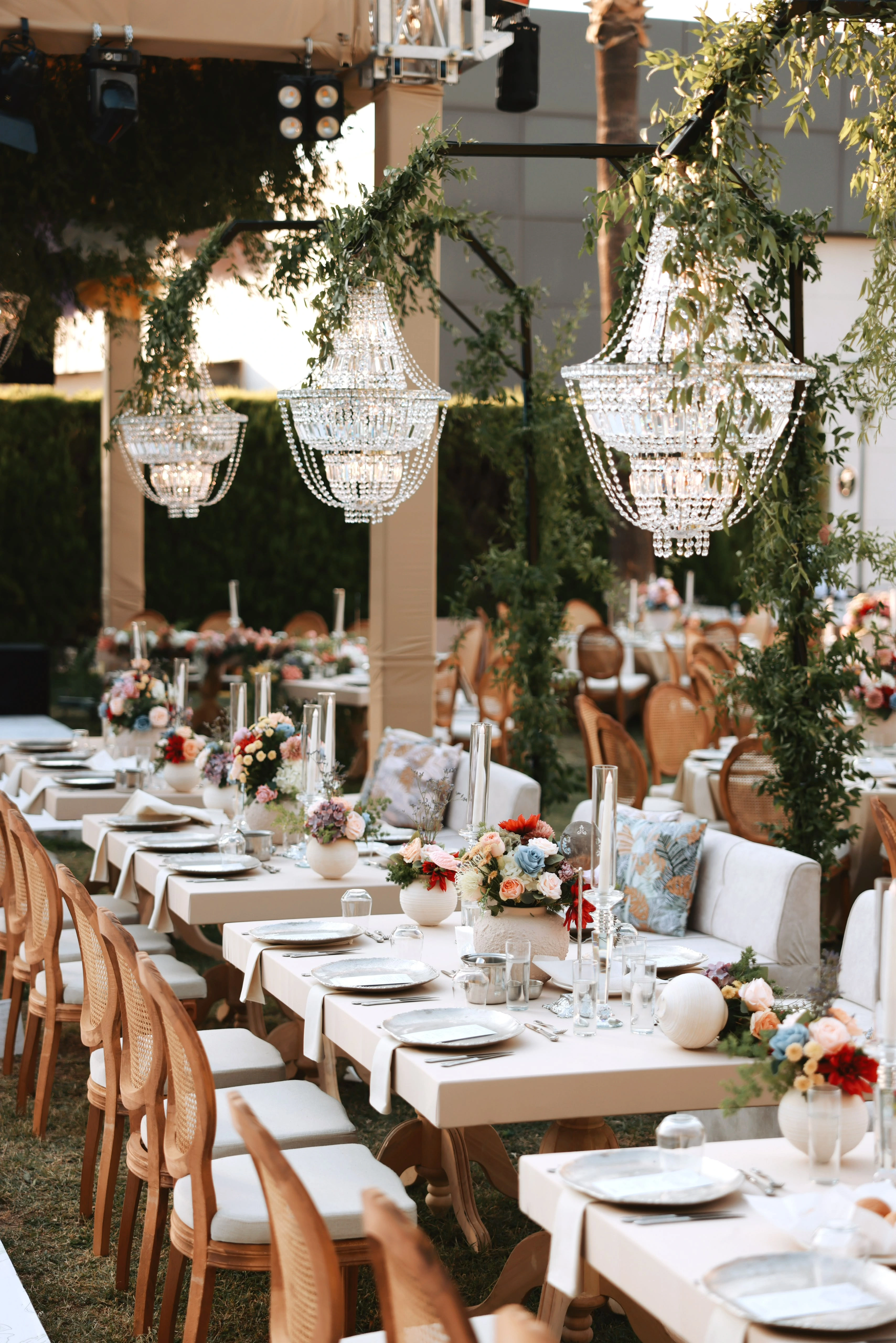 Garden engagement with crystal chandeliers, pastel flowers and wooden chairs, view 17