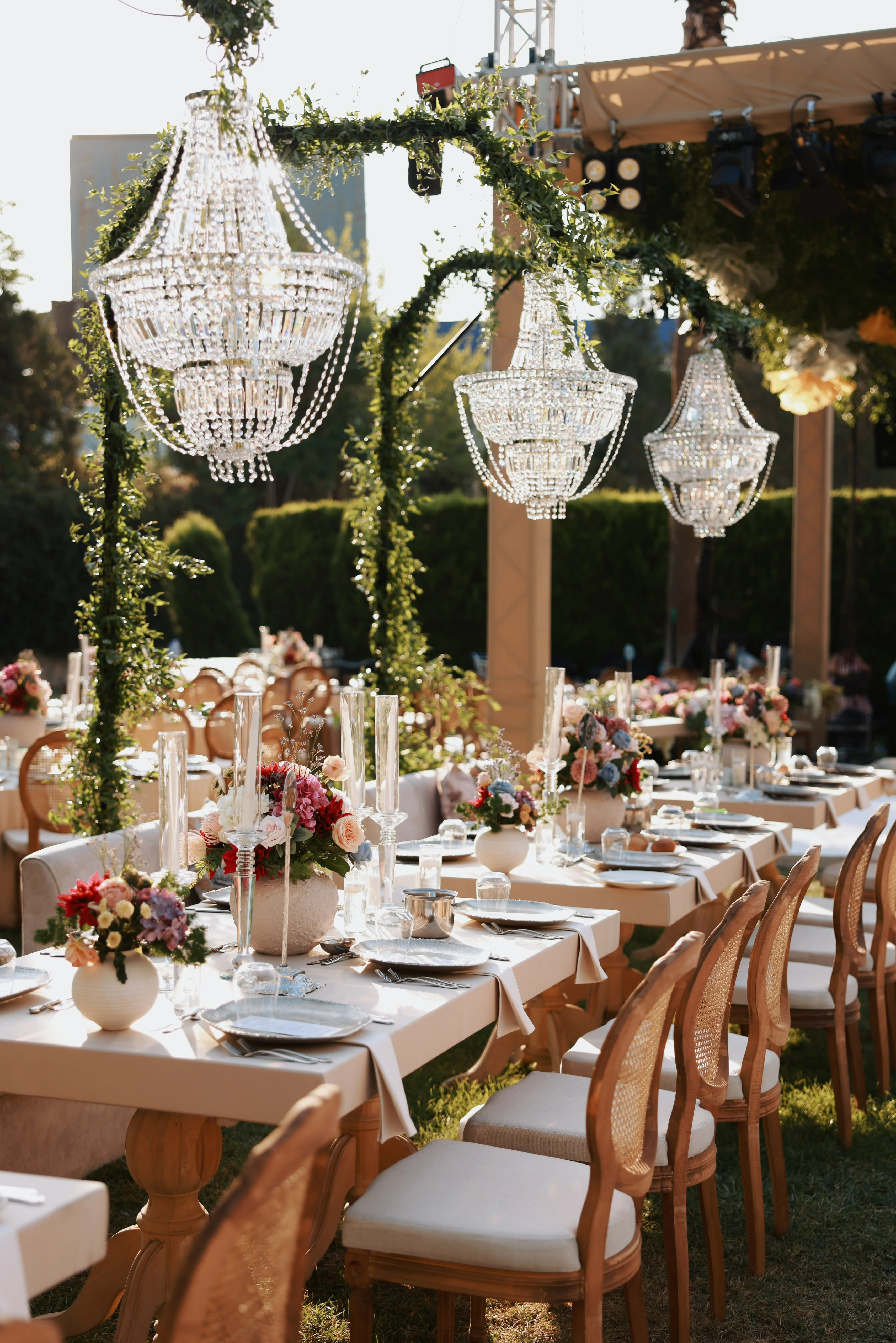 Garden engagement with crystal chandeliers, pastel flowers and wooden chairs, view 18