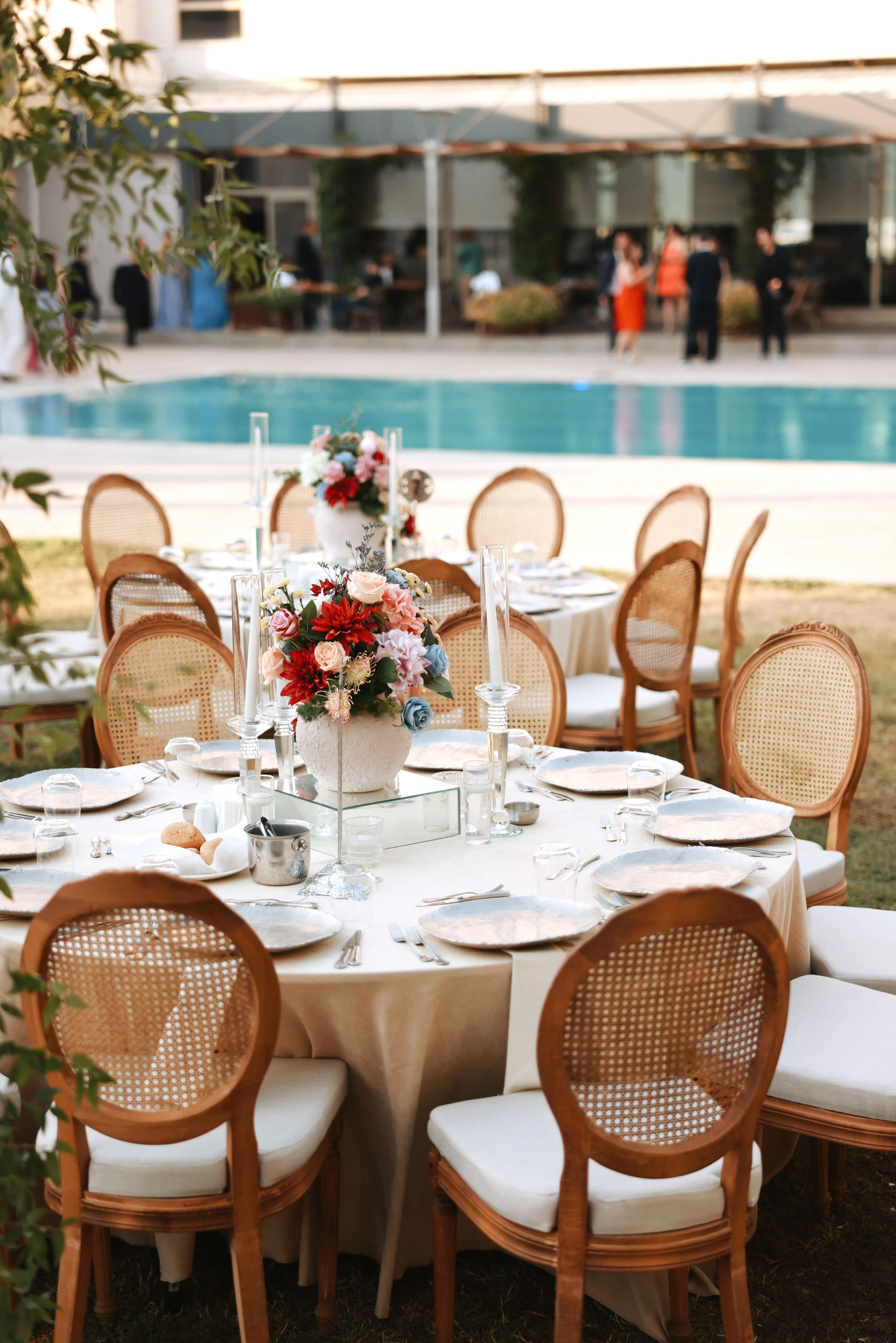 Garden engagement with crystal chandeliers, pastel flowers and wooden chairs, view 19