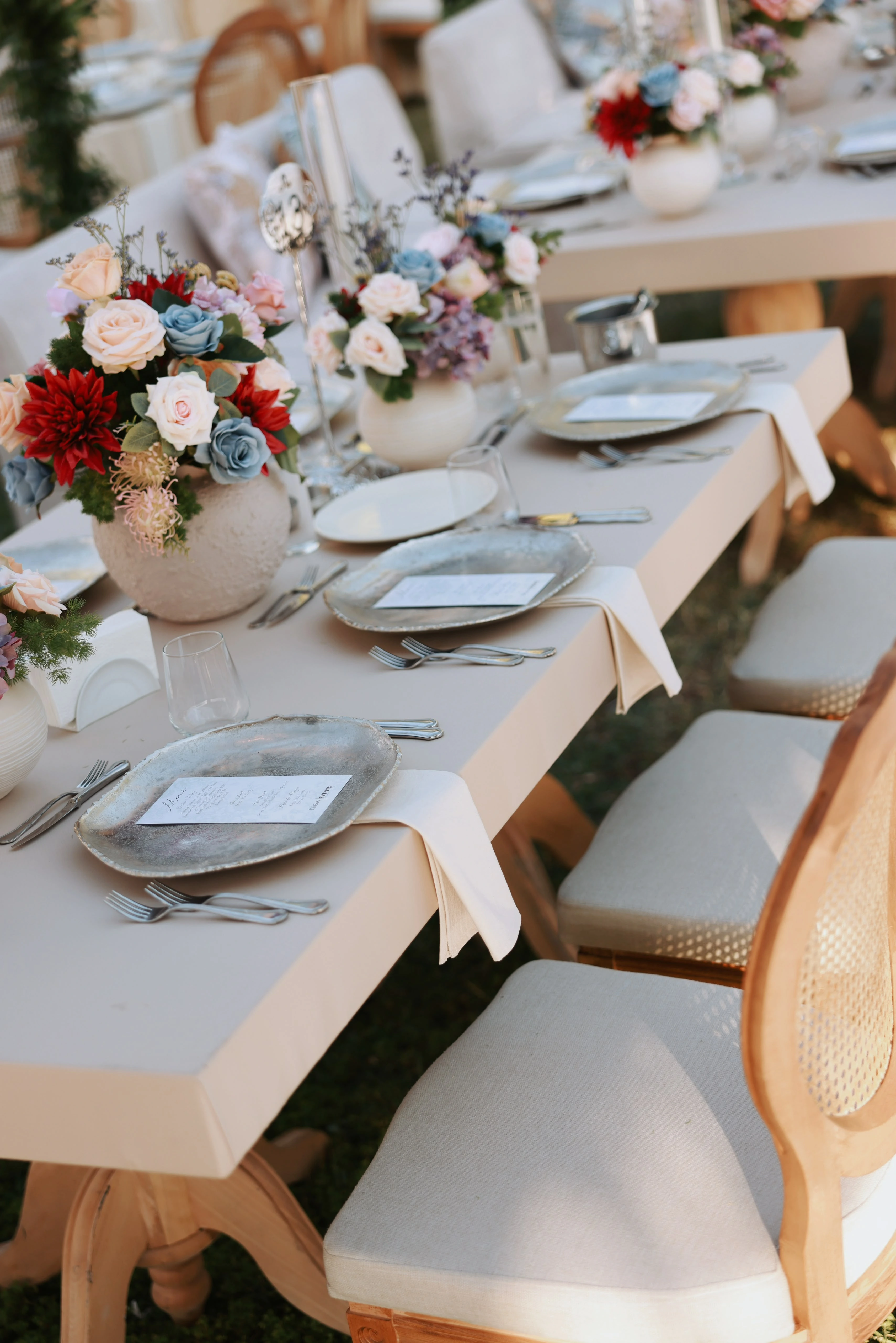 Garden engagement with crystal chandeliers, pastel flowers and wooden chairs, view 25