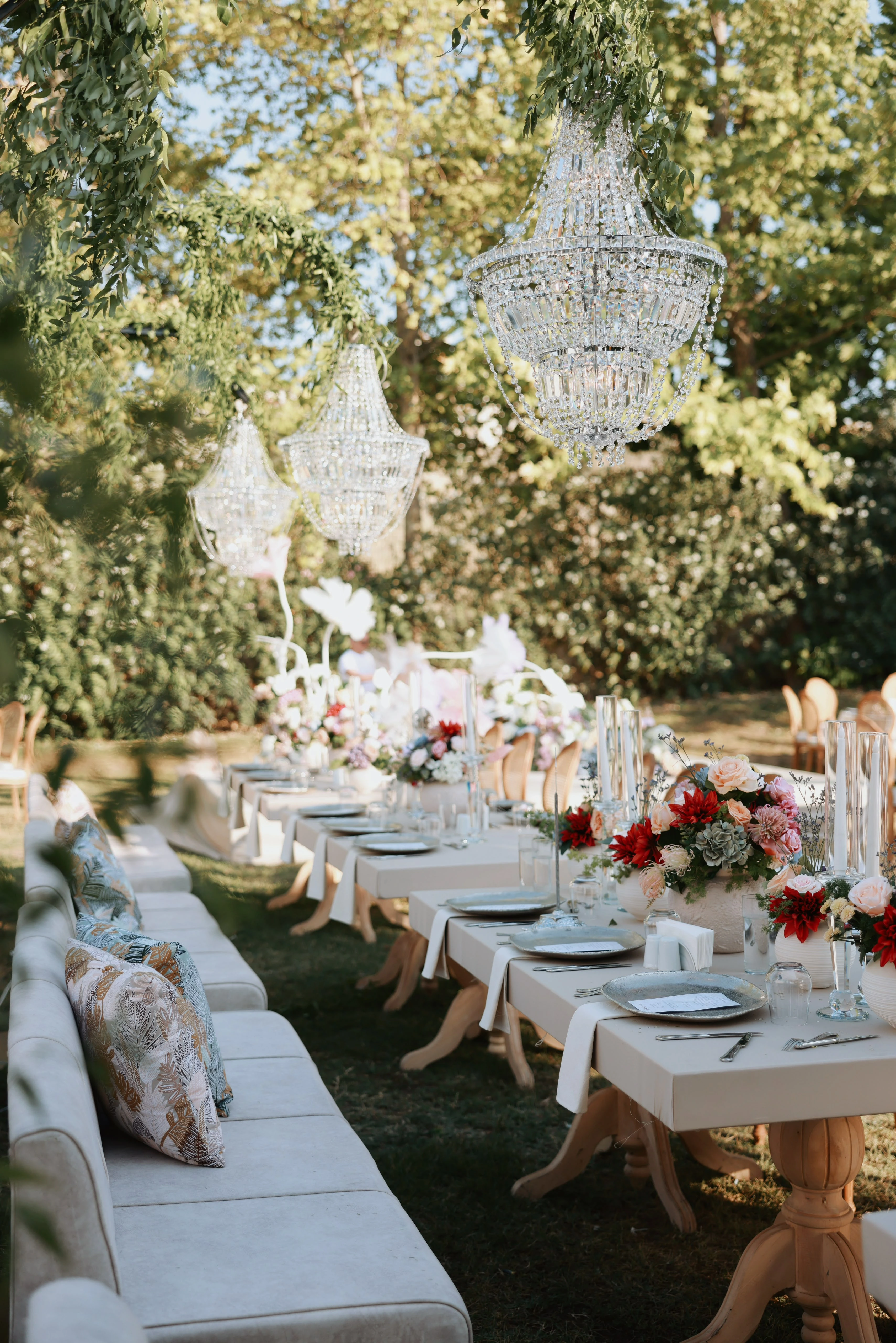 Garden engagement with crystal chandeliers, pastel flowers and wooden chairs, view 26