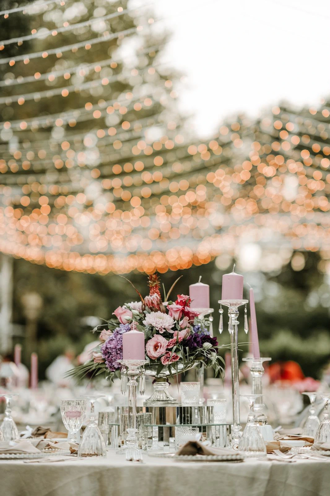 Floral tables and warm string lights in the garden