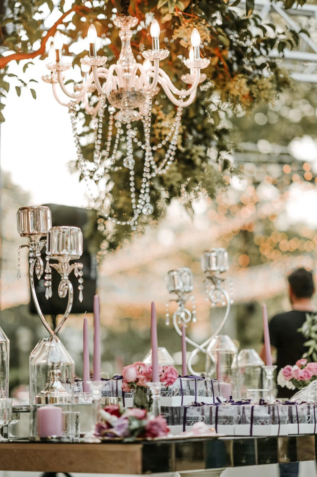 Crystal chandelier, glassware and a pink floral table