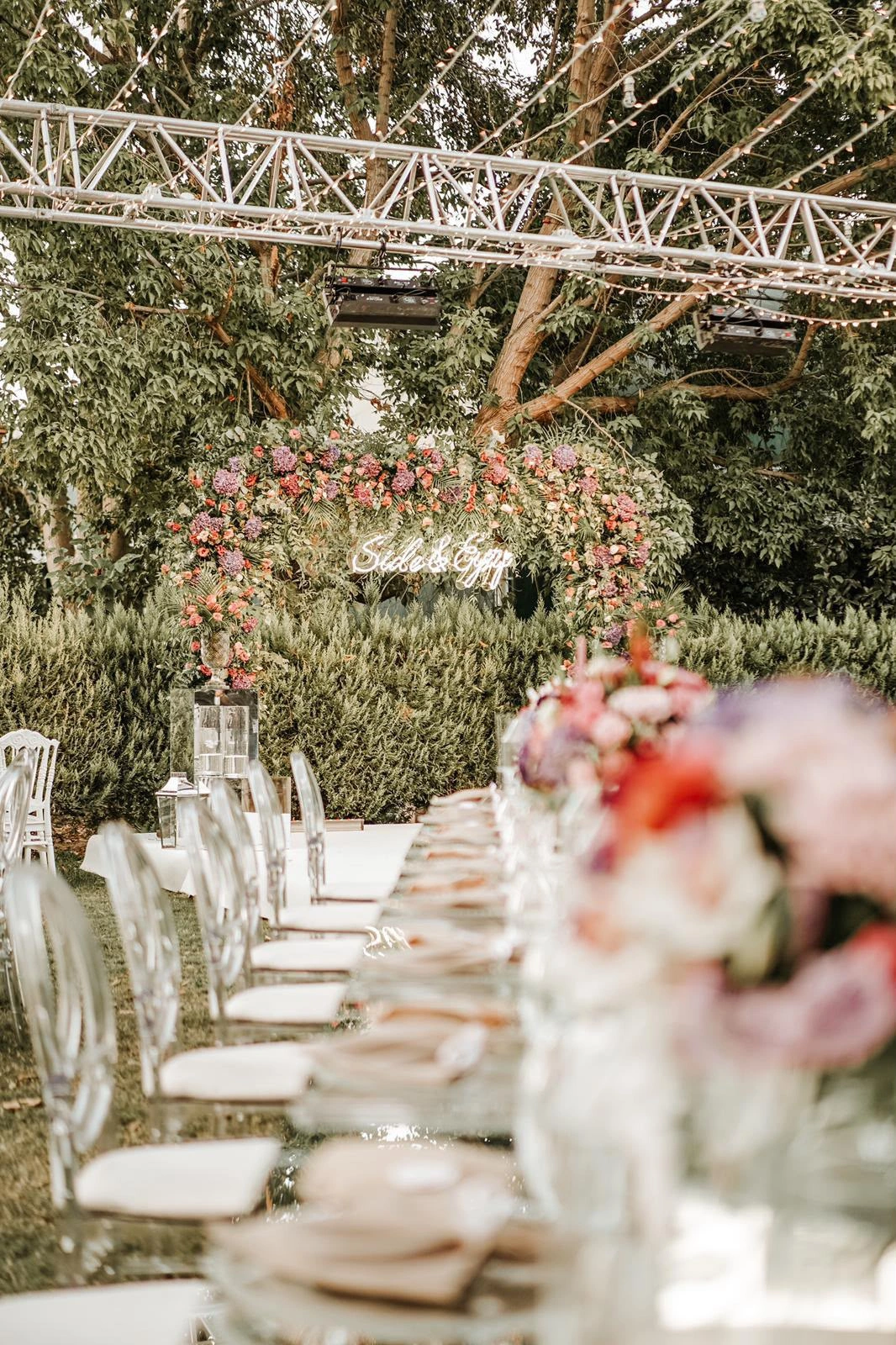 Long table leading to a floral arch in the garden