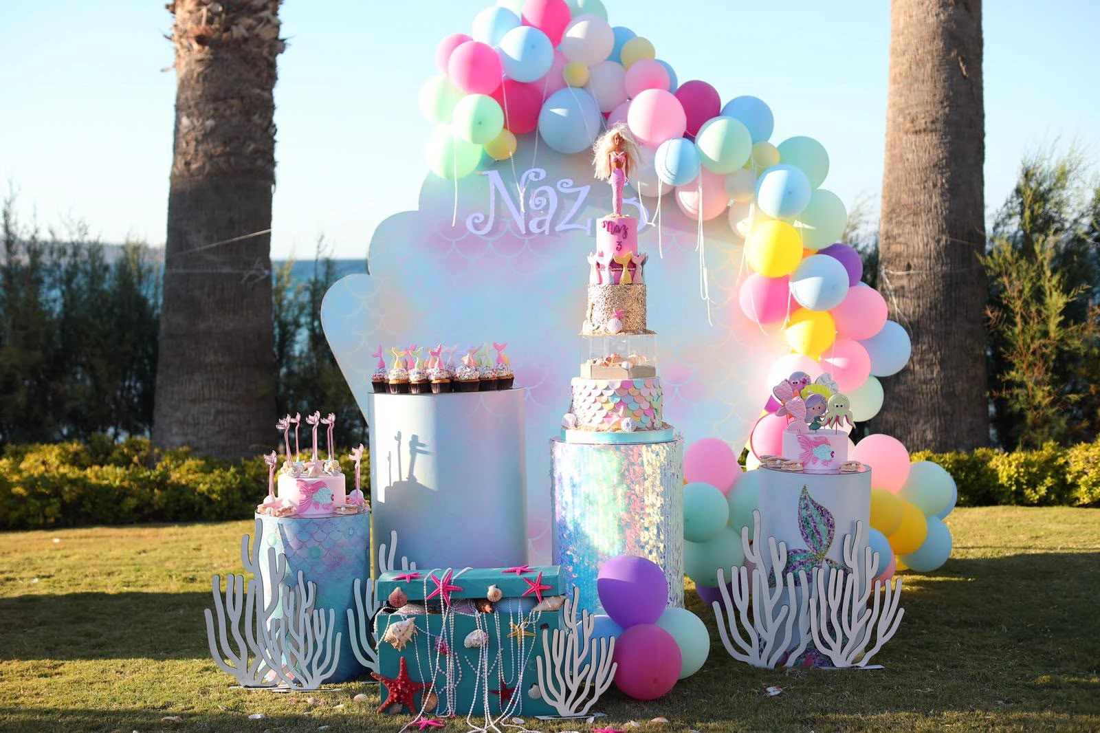 Wide birthday scene with sea figures and colourful balloons